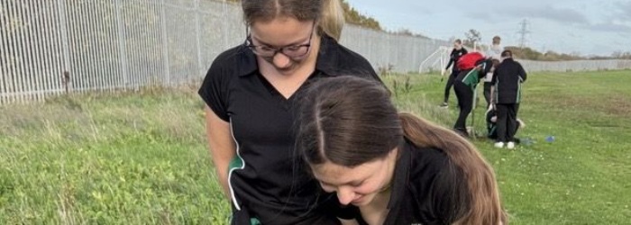 Cranbrook Students planting trees outside in the schools grounds